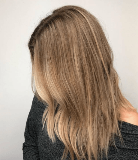 side view image of a woman with blonde brown hair