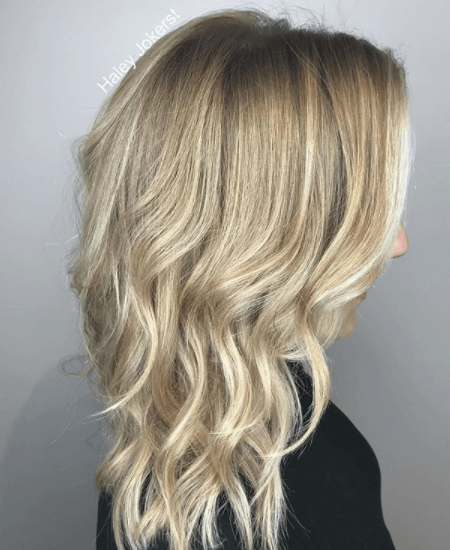 side view image of a woman with blonde wavy hair - blonde brown hair