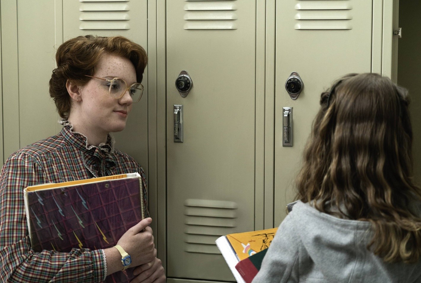 barb from stranger things with her hair pinned up into a retro updo wearing a high neck top