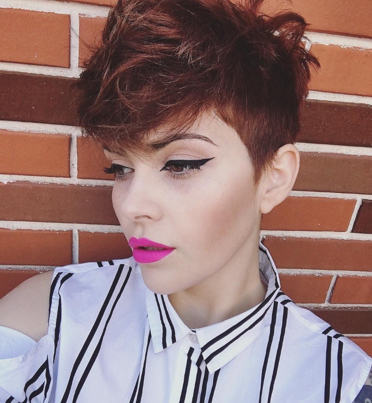 Trendy short haircuts from Instagram: Woman with pixie crop brown hair and pink lipstick