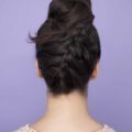 Diwali hairstyles: Back view of a woman with dark brown hair in an upside down French braid bun