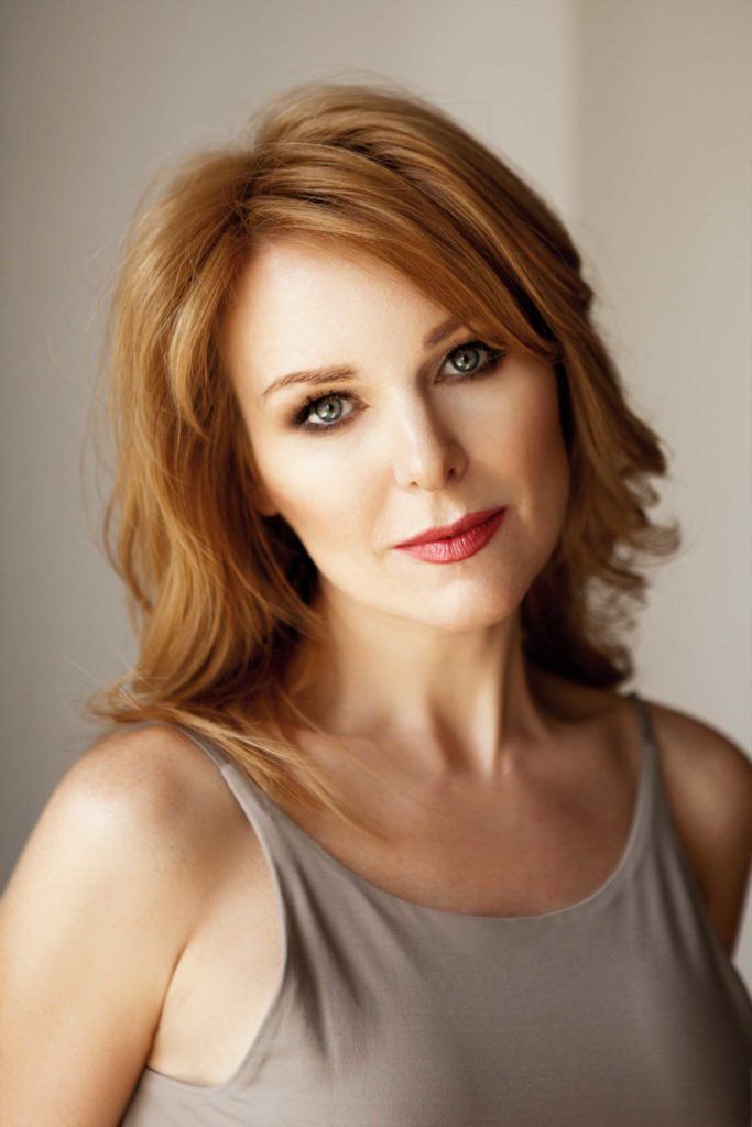 red-haired woman shows us how to style short hair for women over 50