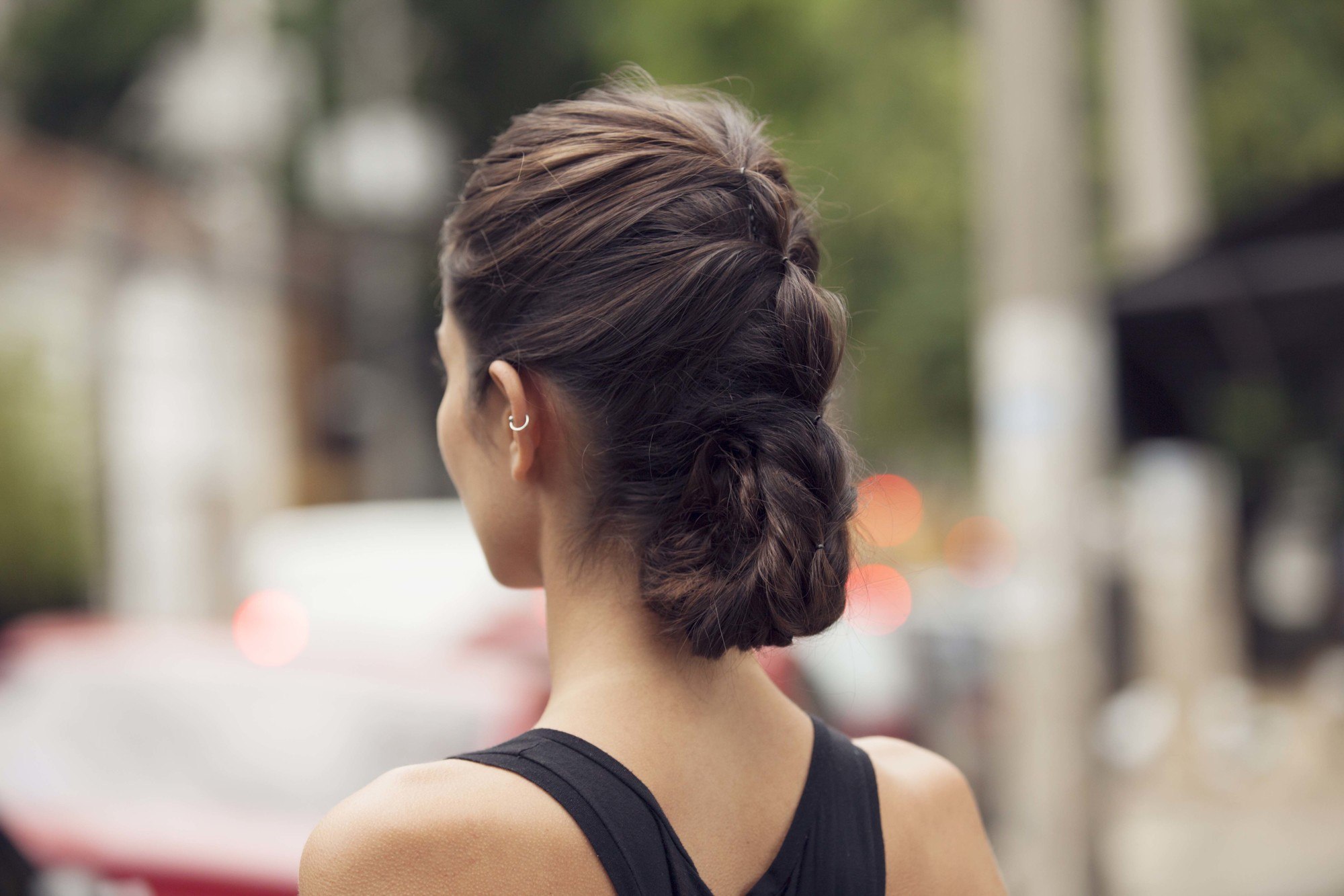 updos for long hair: model with brown hair in fake braid roll hairstyle