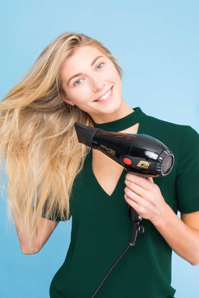 blonde girl blow-drying her