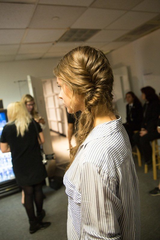 The side view of a model with a messy fishtail braid at the Alice + Olivia New York Fashion Week Show SS17