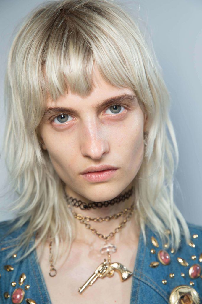 cute short haircuts for women: platinum blonde hair model with a shag cut