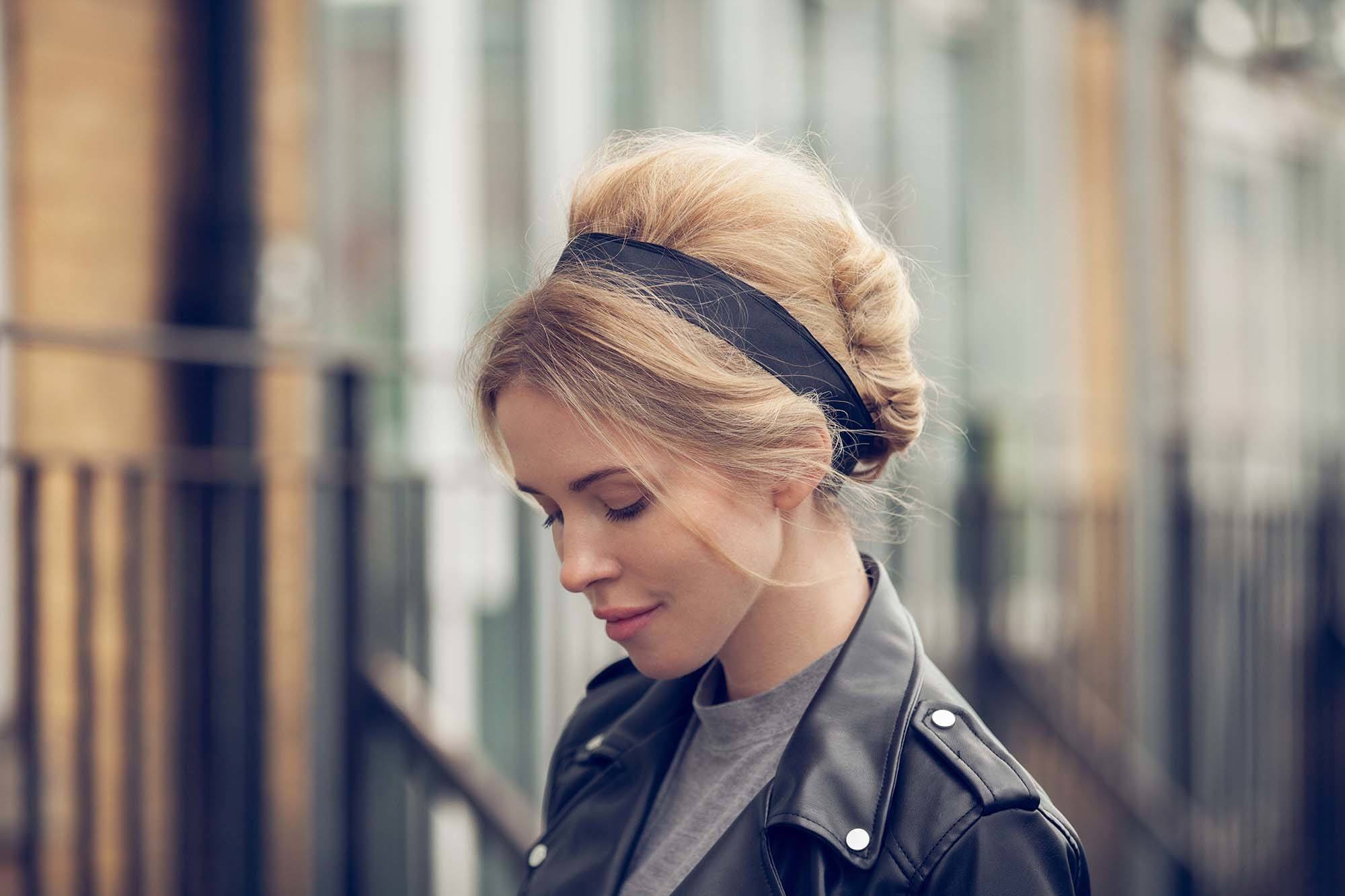 Updos for long hair; model with long blonde hair styled into a french twist hairstyle