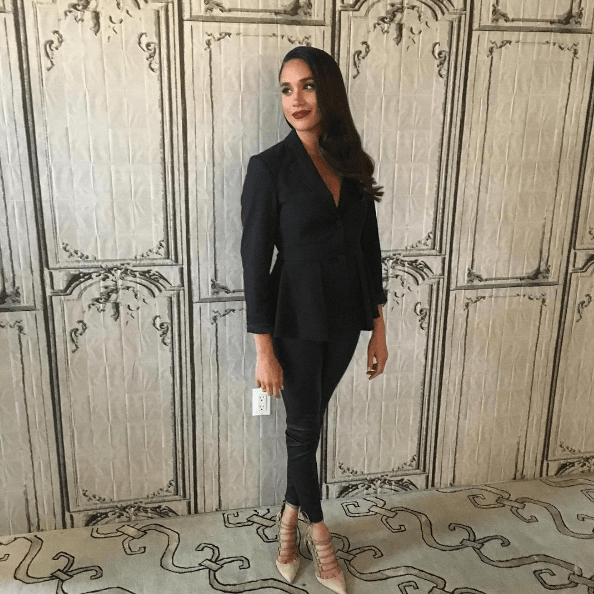 Meghan Markle Insta post of the actress wearing her hair side swept and wearing a pant suit