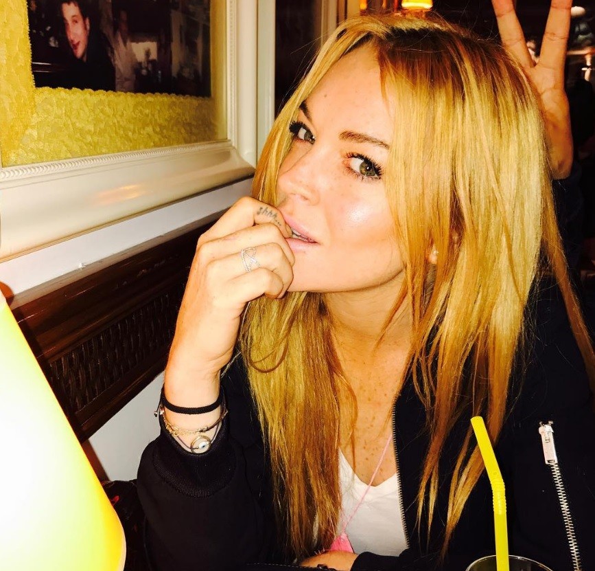 Lindsay Lohan with strawberry blonde hair and dark roots