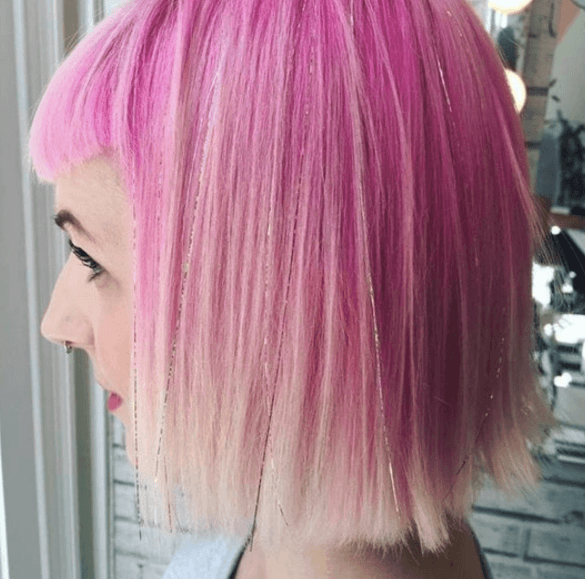 side view of a womans pink bob with tinsel hair