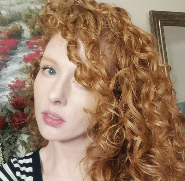 front view of a woman with strawberry blonde curly hair