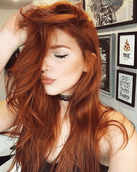 front view image of a woman with long red hair