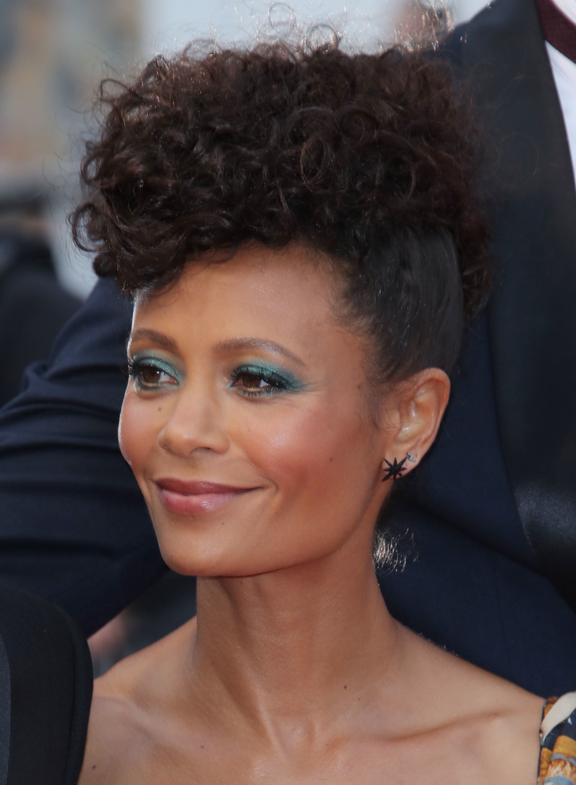 Curly hair hairstyles: Thandie Newton with dark brown naturally curly hair styled in a frohawk