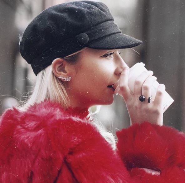 side view of light blonde hair and black baker boy hat