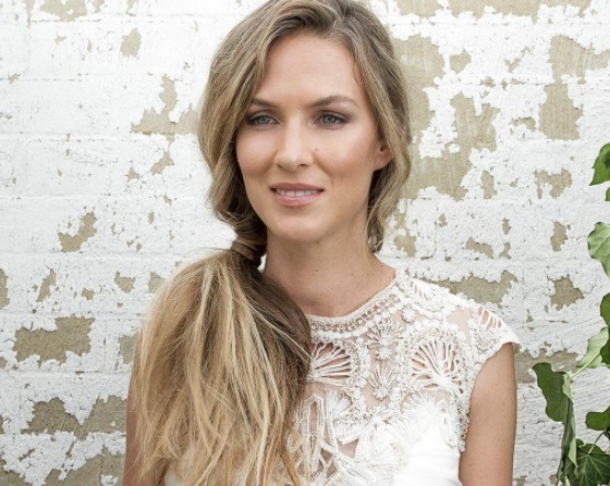 bride with messy side ponytail hairstyle and wedding dress