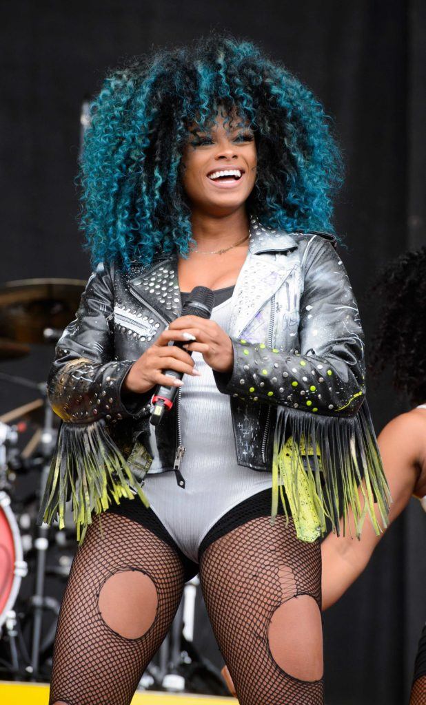 close up shot of fleur east with blue ombre curly afro wearing bodysuit on the stage
