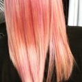 woman with straight pink and peach fruit salad coloured hair