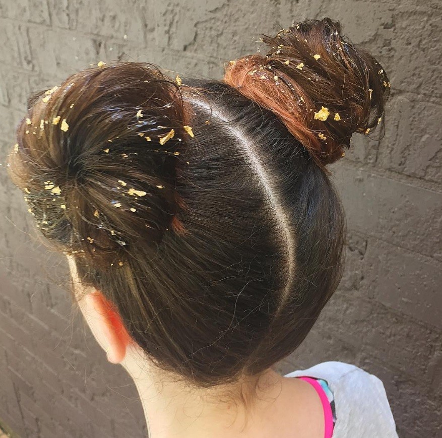 Hair foil - brown hair in two space buns style with gold foil in the buns