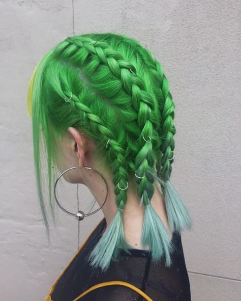 side view of green braided hair with hair rings