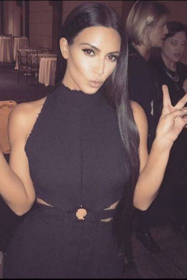 hairstyles for long straight hair: Kim Kardashian Instagram picture of her wearing a black dress with long straight hair