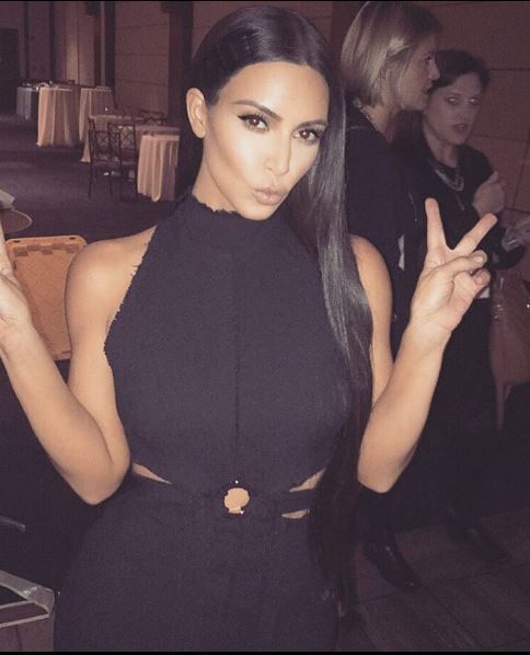 hairstyles for long straight hair: Kim Kardashian Instagram picture of her wearing a black dress with long straight hair