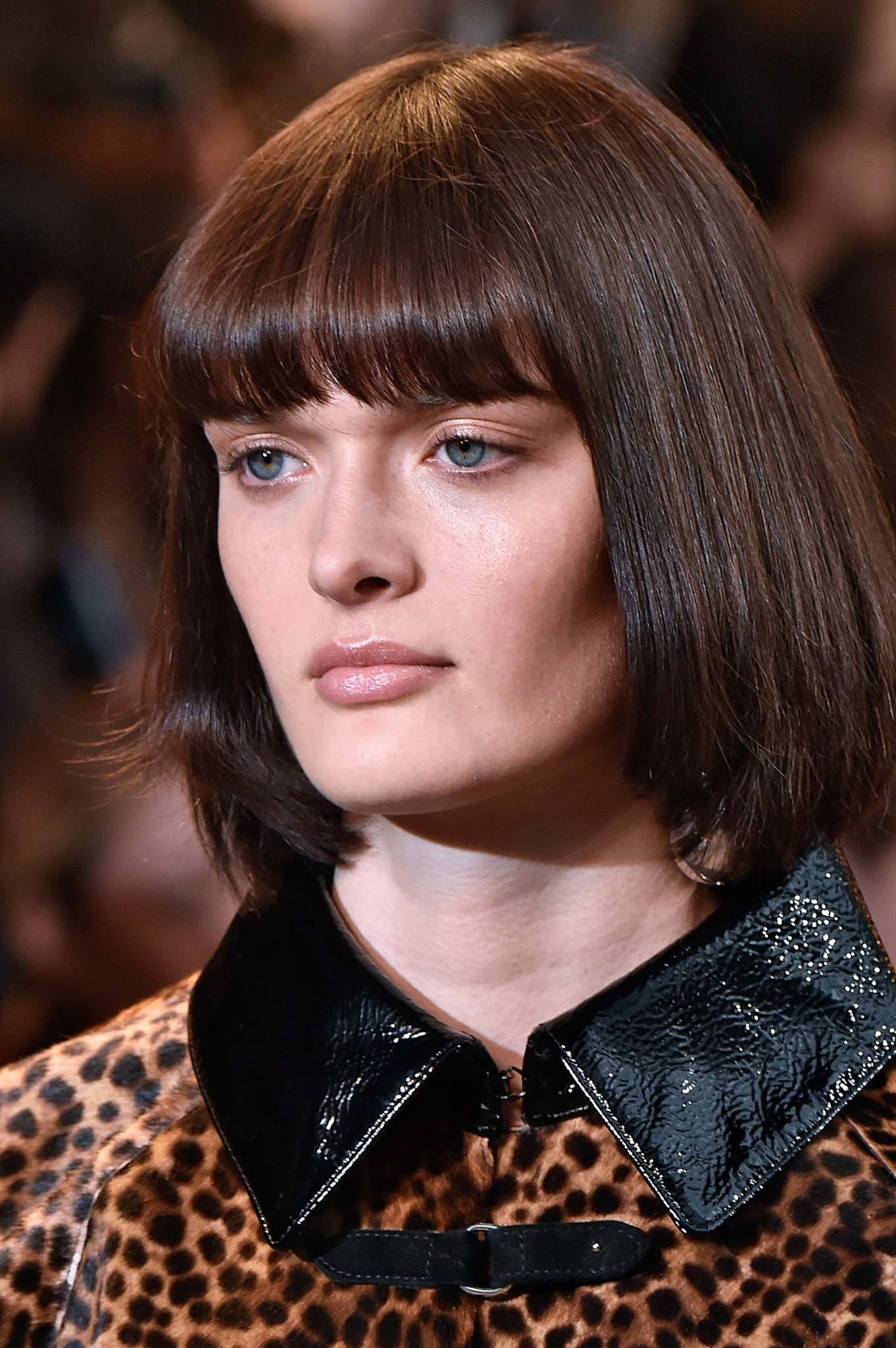 Retro hairstyles: Close up shot of a model with chestnut brown bob with bangs on the Isabel Marant runway