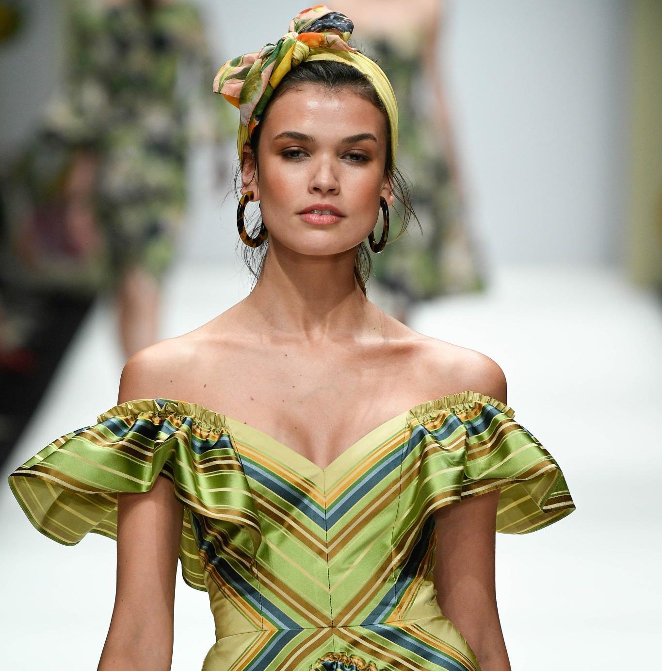 Retro hairstyles: Close up shot of a model on the Lenah Schek runway with a printed scarf wrapped around her hair