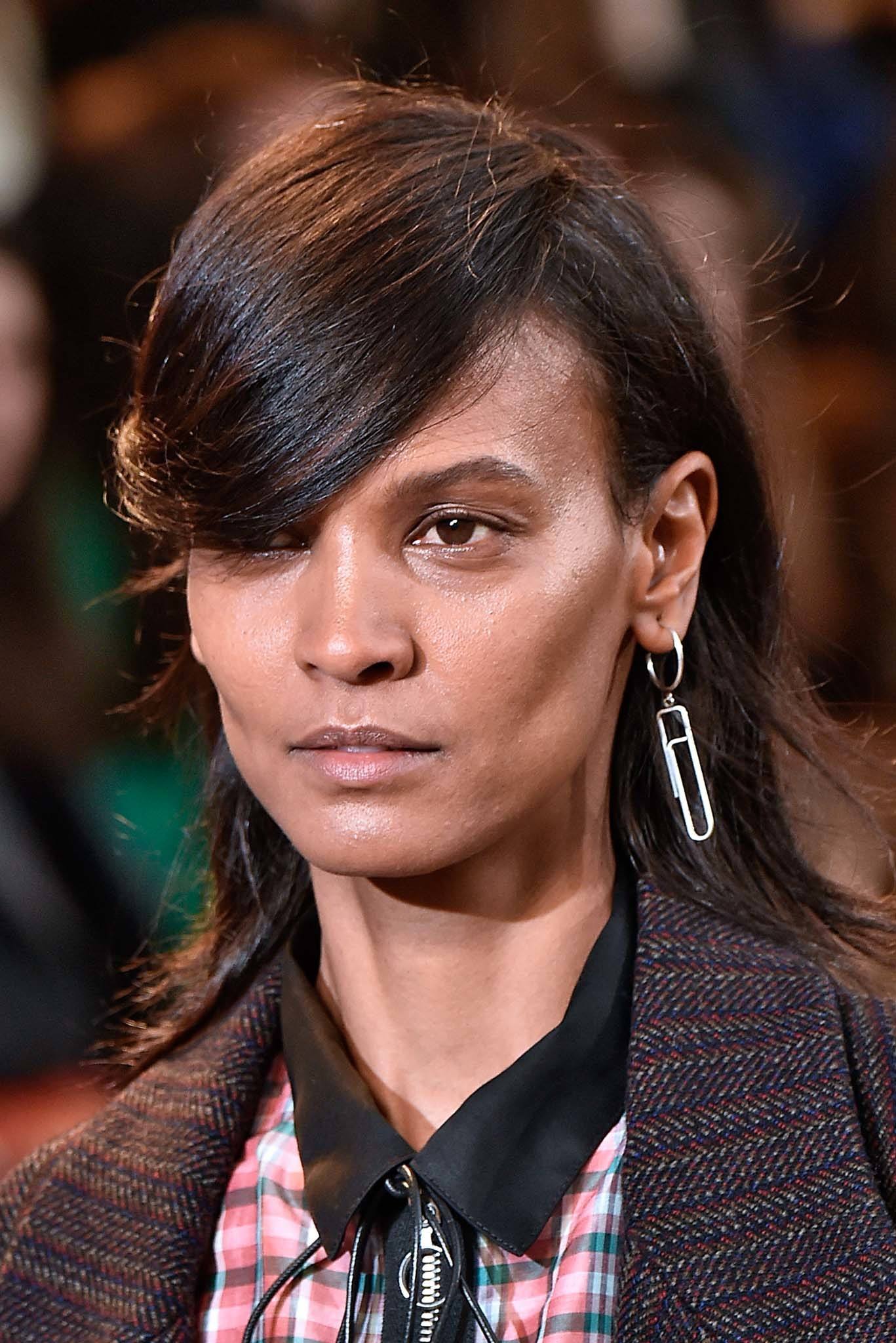 Retro hairstyles: Close up shot of a woman with chocolate brown medium relaxed hair styled into a retro swoop on the Isabel Marant runway