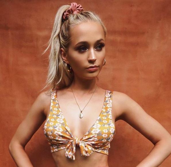 front view of blonde model with long hair in high ponytail with pink scrunchie