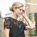 hair up styles: blonde model with a wavy vintage updo and hair accessory wearing a black lace top