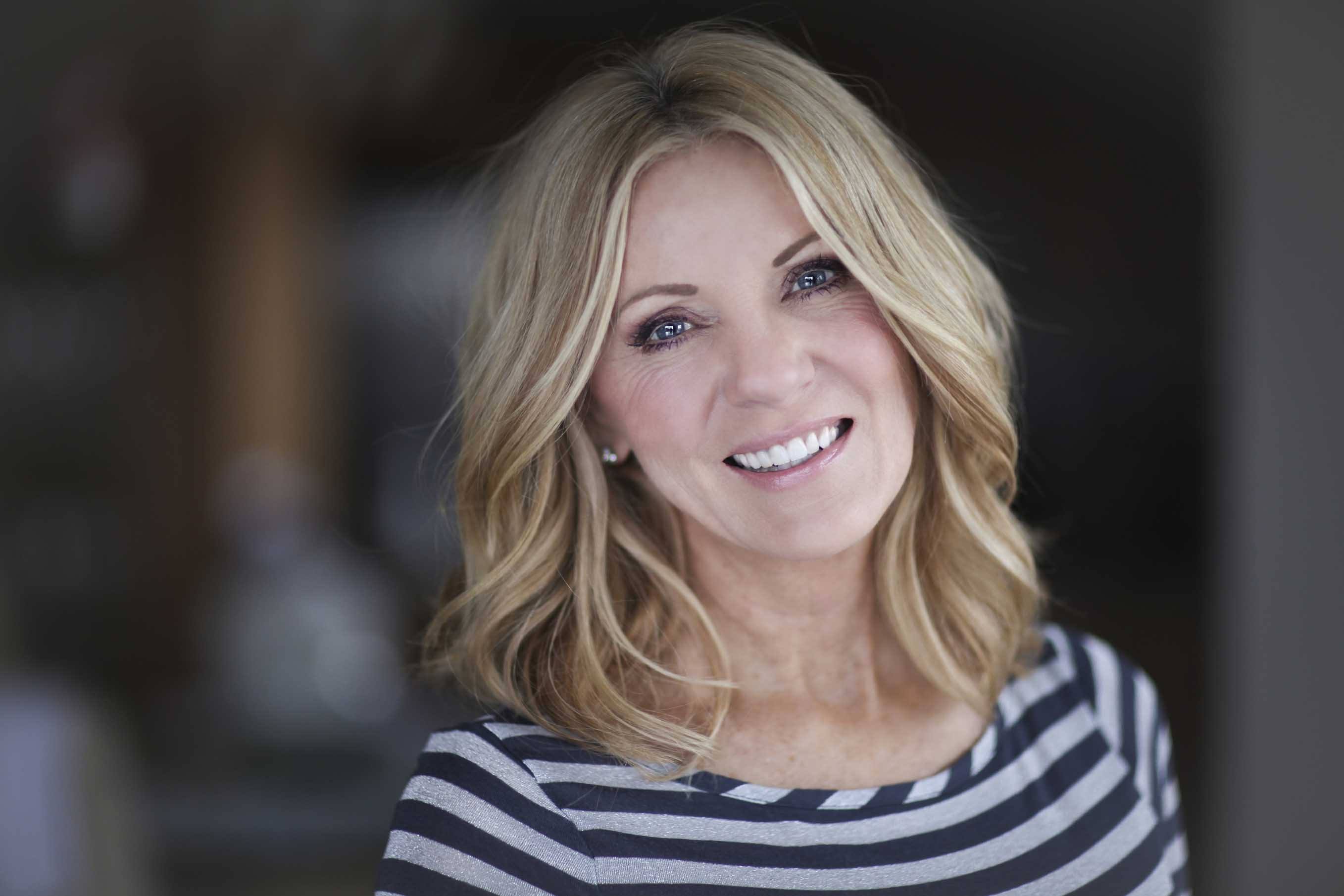 mature woman with shoulder length blonde highlighted hair