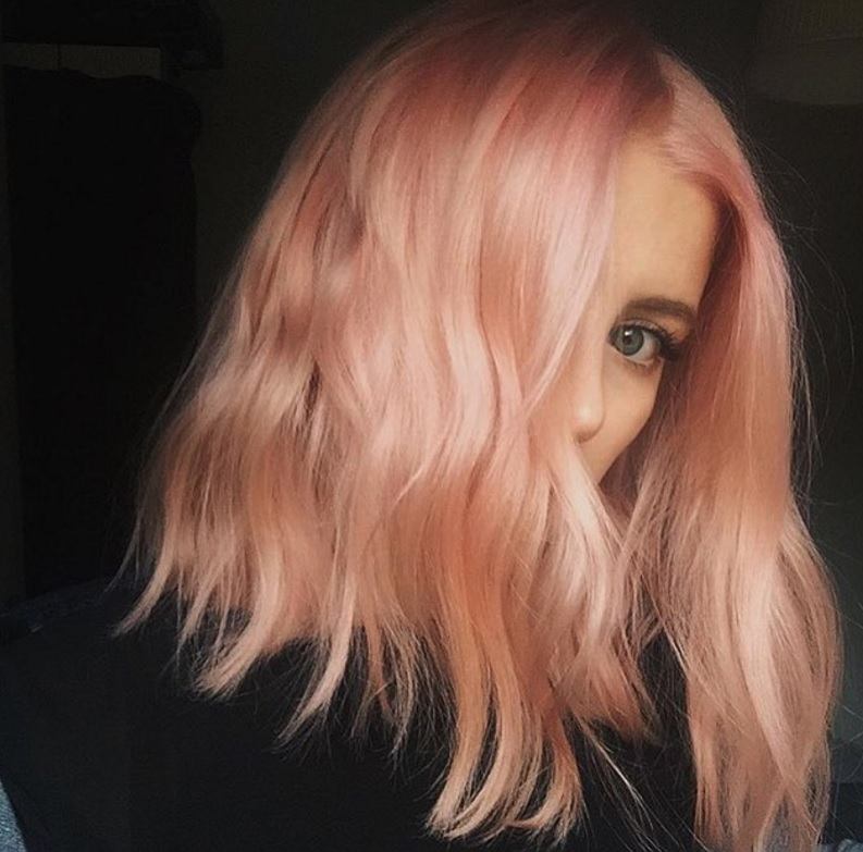 woman with a peach hair colour and a wavy long bob