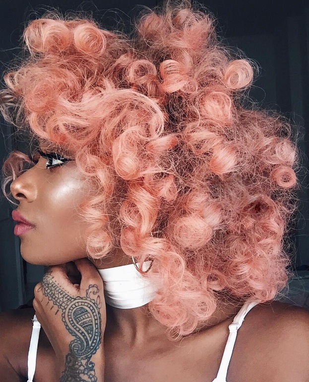 woman with naturally curly hair with blorange hair colour trend