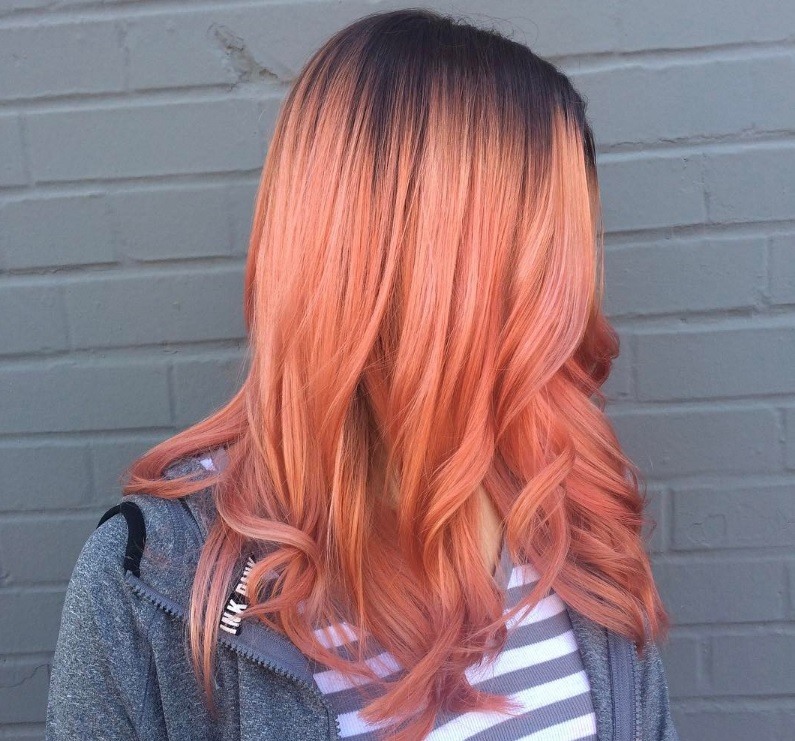 woman with ombre blorange peach hair and shadow roots