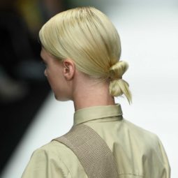 back view of a blonde runway model at the danny reinke show at berlin fashion week with her hair in a low tucked bun