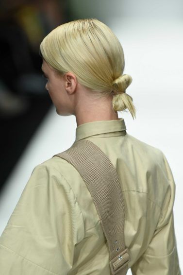 back view of a blonde runway model at the danny reinke show at berlin fashion week with her hair in a low tucked bun