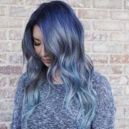 An Instagrammer with wavy denim blue ombre hair