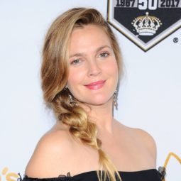 drew barrymore with blonde hair wearing a low loose braid