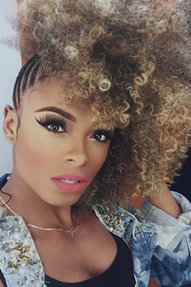 Fleur East with curly afro