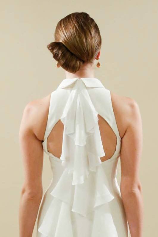 Wedding updos: Back view of a brunette model at Matthew Christopher Bridal show FW17 with a modern French Twist hairstyle
