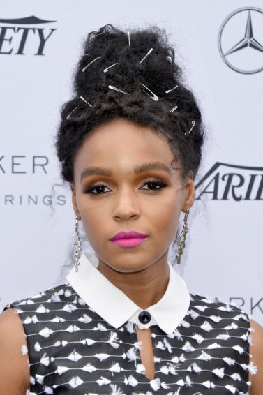 Janelle Monae wearing her hair in an updo on the red carpet with gold wiring pulled through