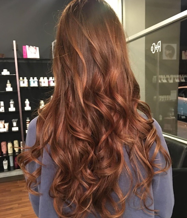 Woman with curly auburn hair hygge trend