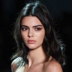Kendall Jenner with dark shoulder length hair walking on the runway