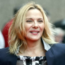 Kim Cattrall with lob hairstyle in grey and black suit