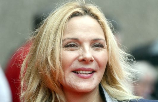 Kim Cattrall with lob hairstyle in grey and black suit