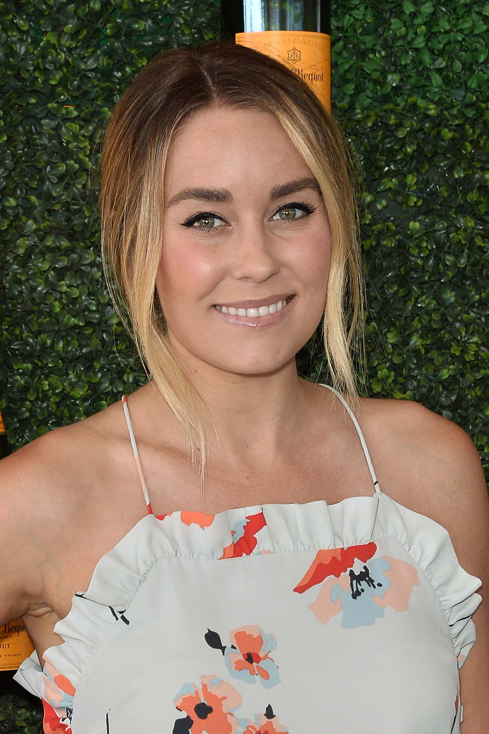 Lauren Conrad with medium brown hair with highlights in a floral dress