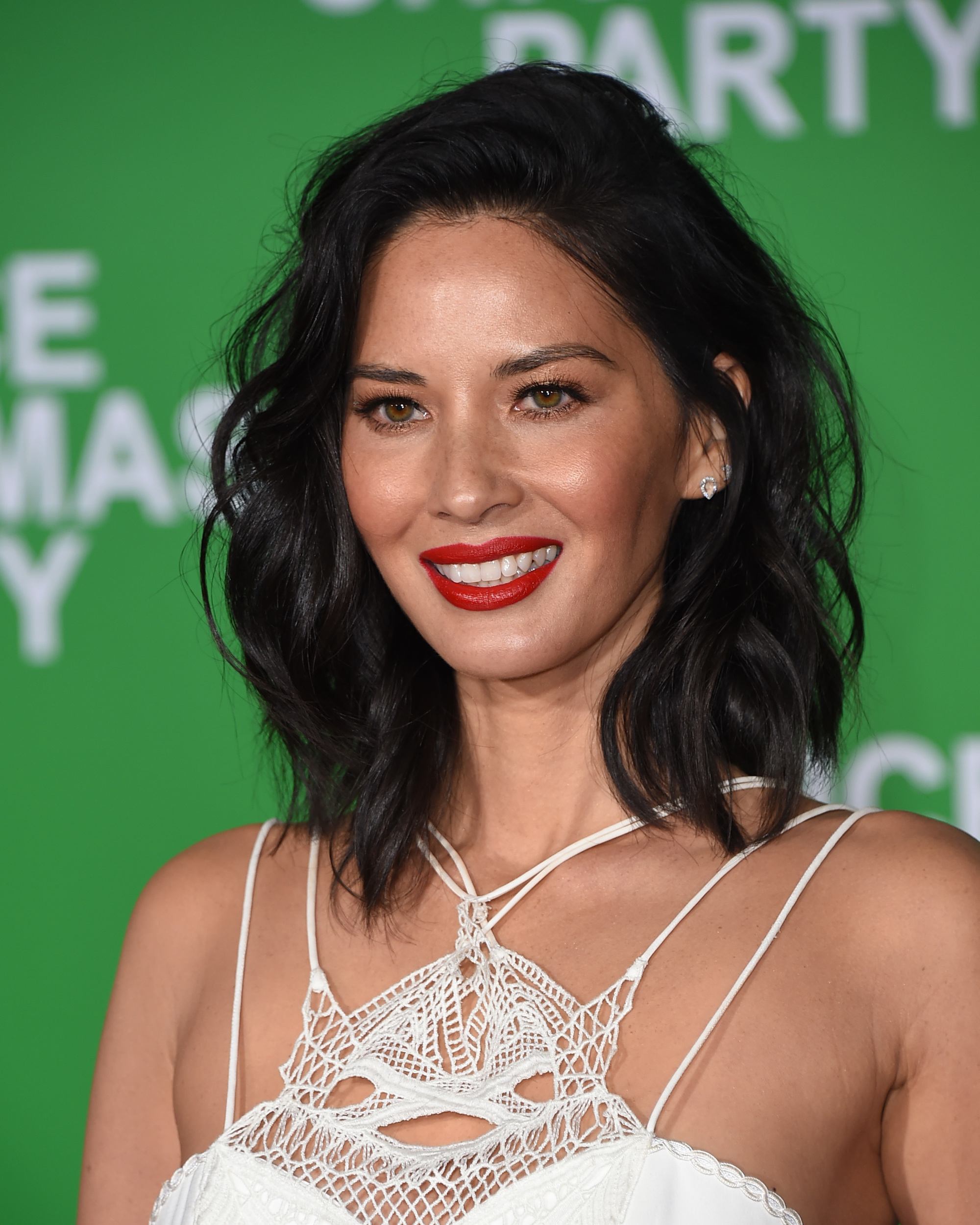 Close up of Olivia Munn with curly lob bob haircut in white dress long bobs for thick hair