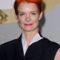 Sandy Powell with bright orange red cropped hair