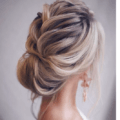 back view of a woman with a loose french plait and low bun
