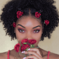 natural hairstyles for short hair: shot of woman with bantu knots and short natural hair with flowers in them